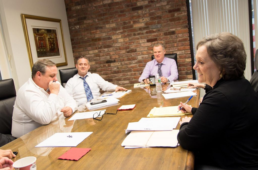 A team of people sitting around a conference table